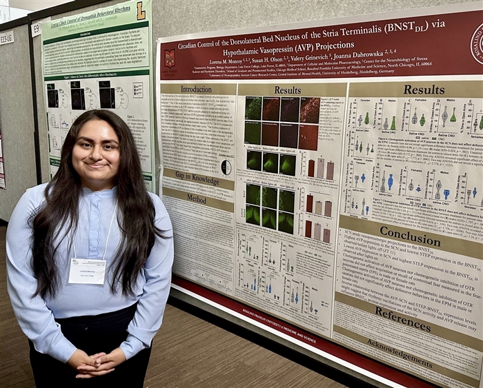 Female student in front of research poster