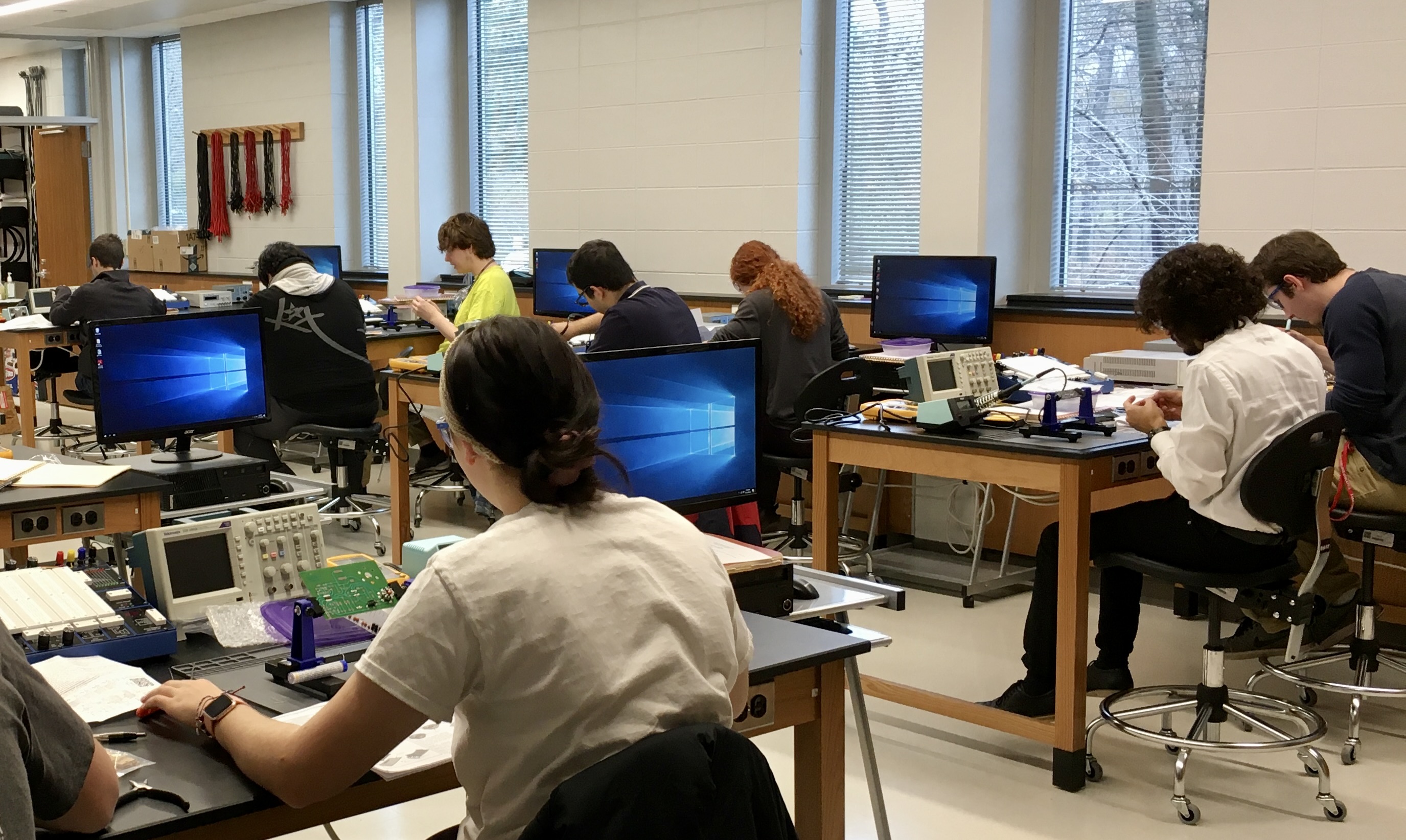 students soldering in electronics lab