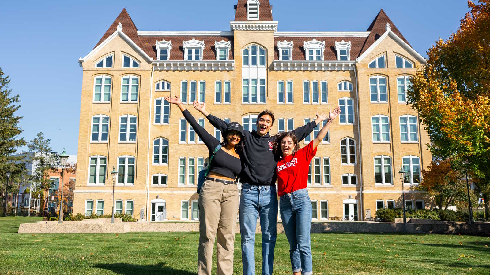 students cheering in front of Brown Hall on campus