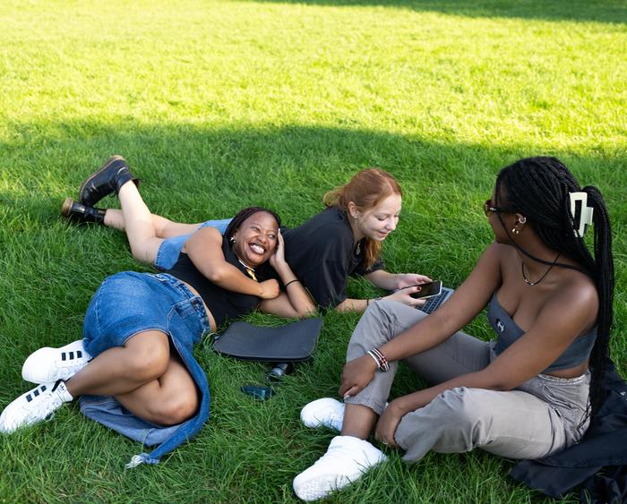 students lying in the grass