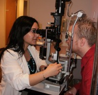 Karina Nikogosian ‘07 examines the interior of the eye at her optometry externship