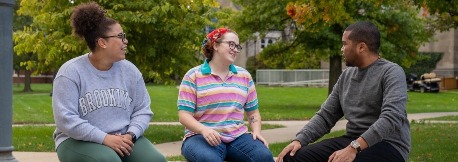 students and professors sit outside
