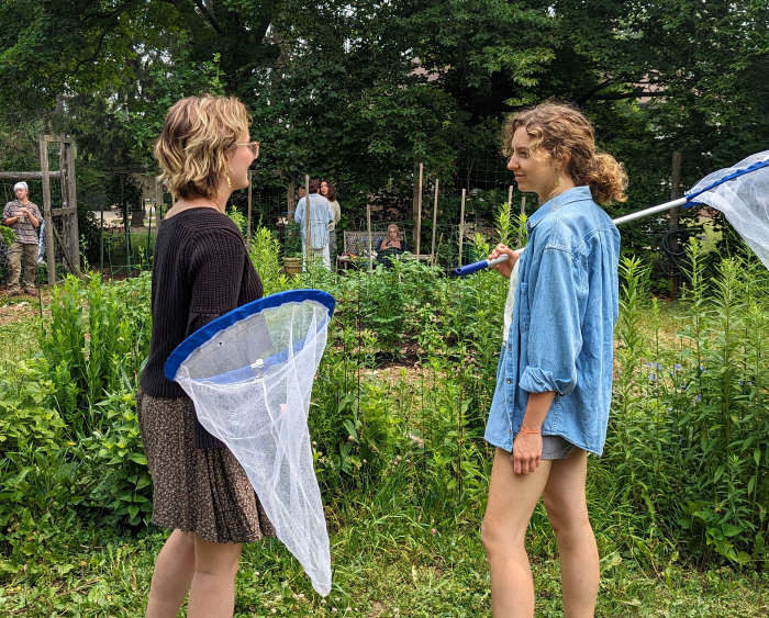 bowen and anna with nets to catch moths in the student garden