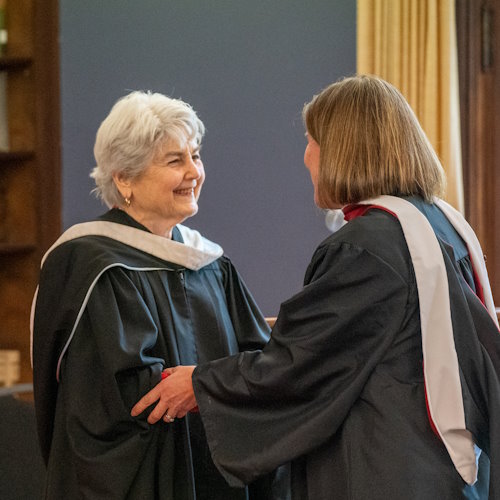 Carol Gayle presenting a diploma to an MLS graduate