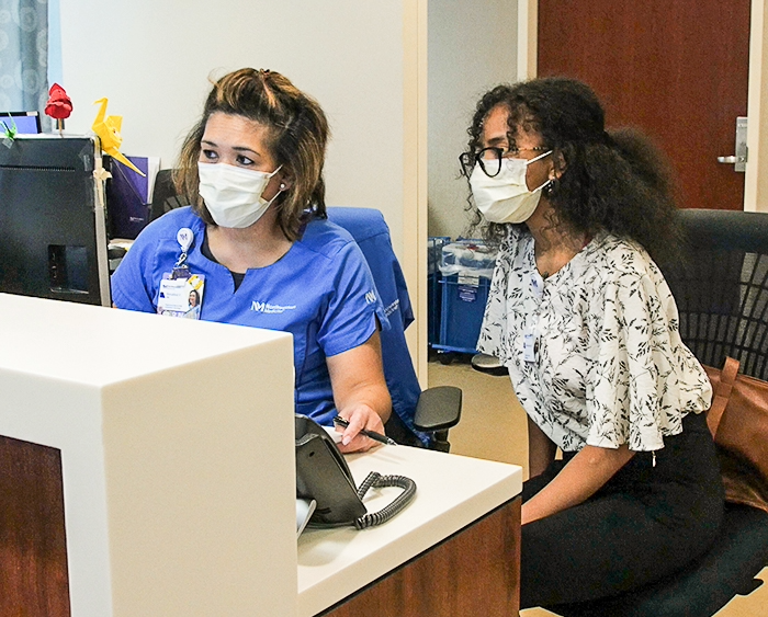 a student working with a professional healthcare worker