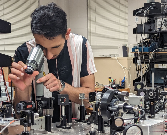 student looking through a scope