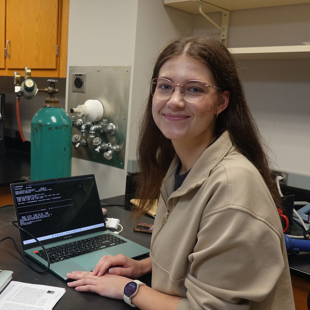 Sofia Strupovets in a physics lab with a laptop