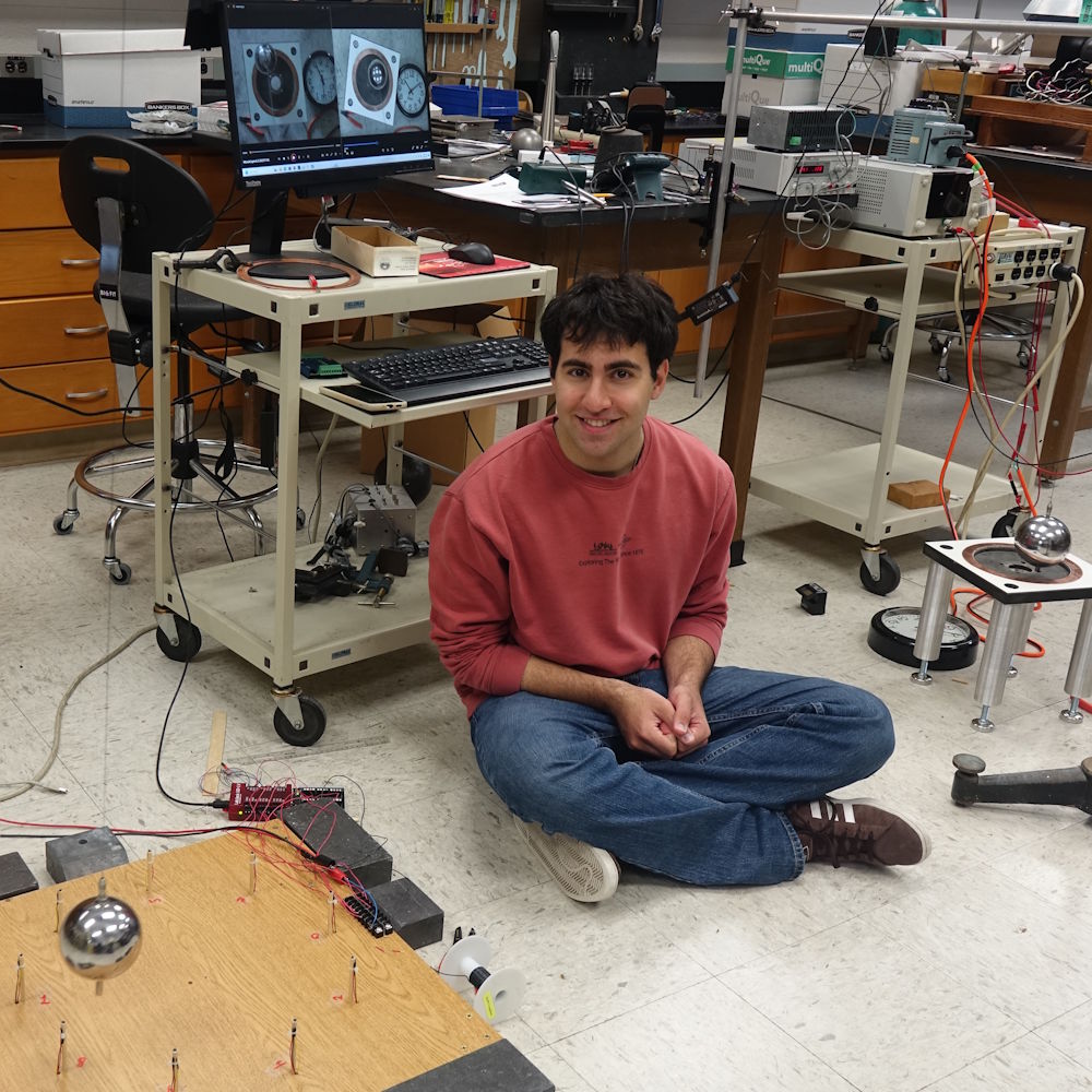 Van Baghdasaryan in a physics lab with a pendulum visible in the foreground