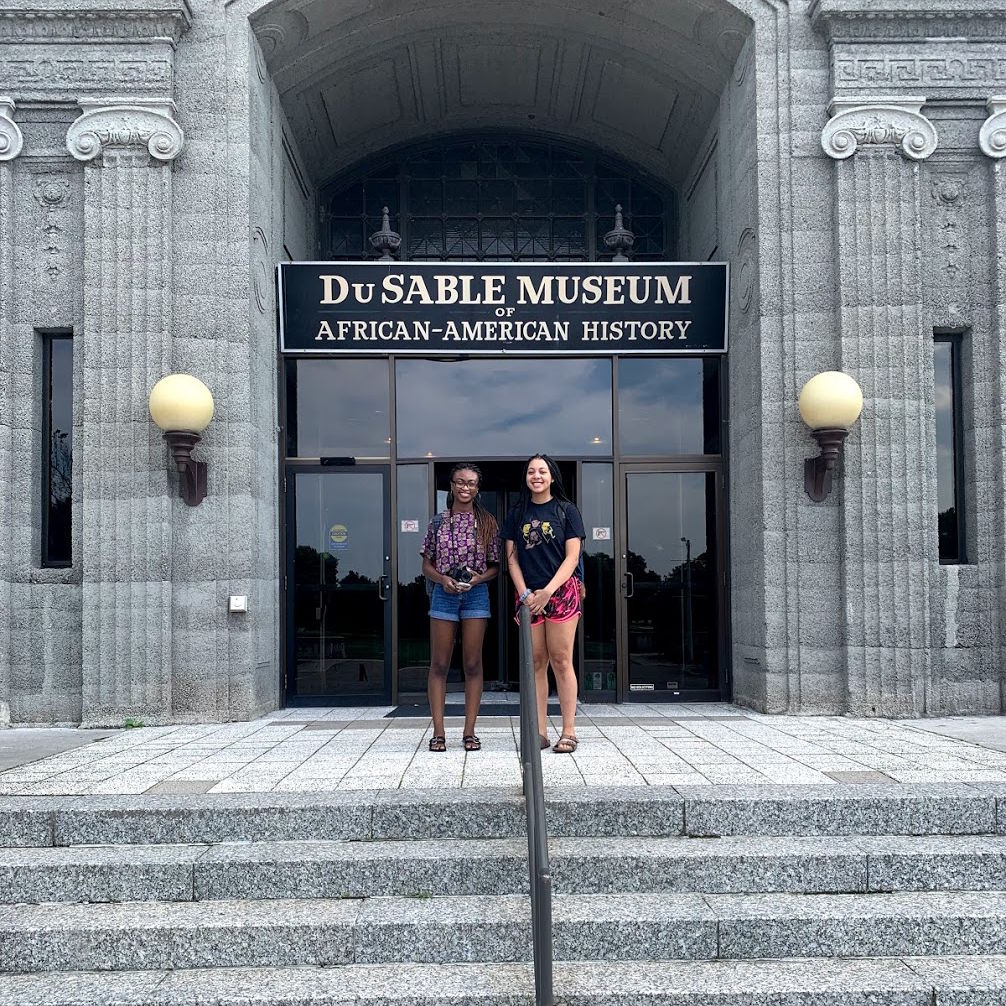 two students standing in front of the dusable mseum of african american history