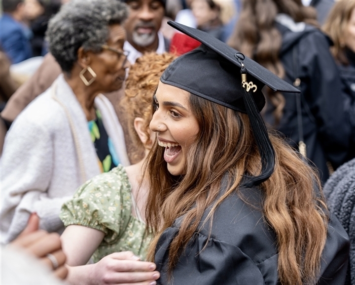 Grad in cap and gown in crowd