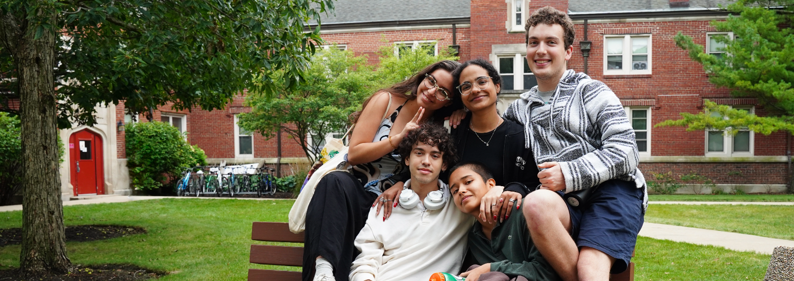 students sitting on a bench smiling