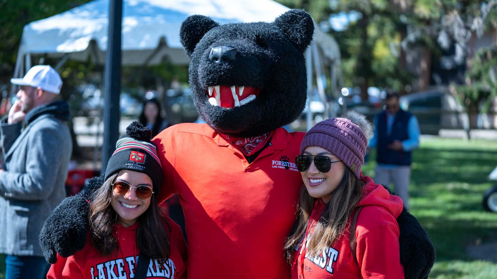 two students with Boomer, the lake forest college mascot who is a bear