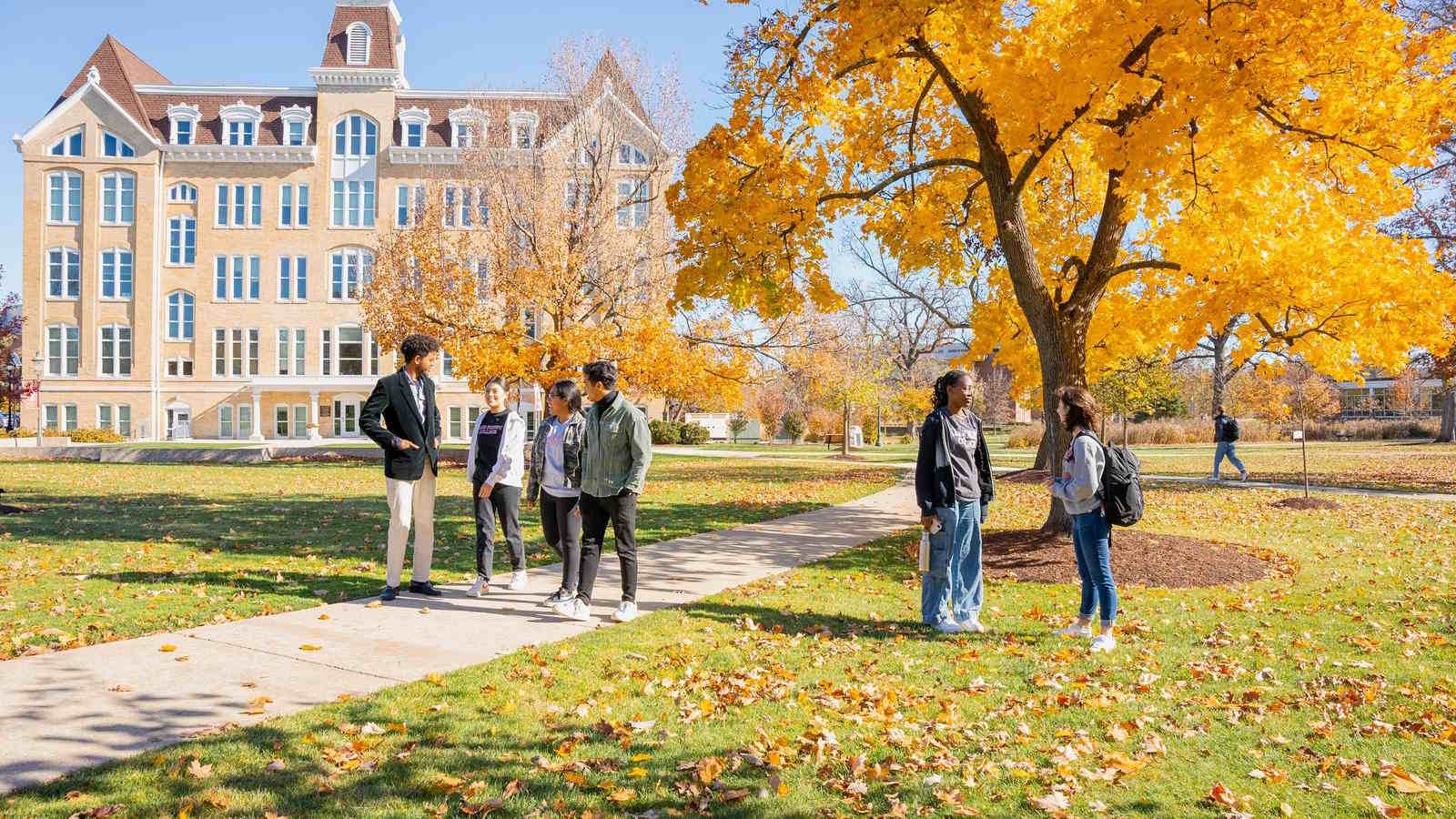 students conversing in front of Brown Hall