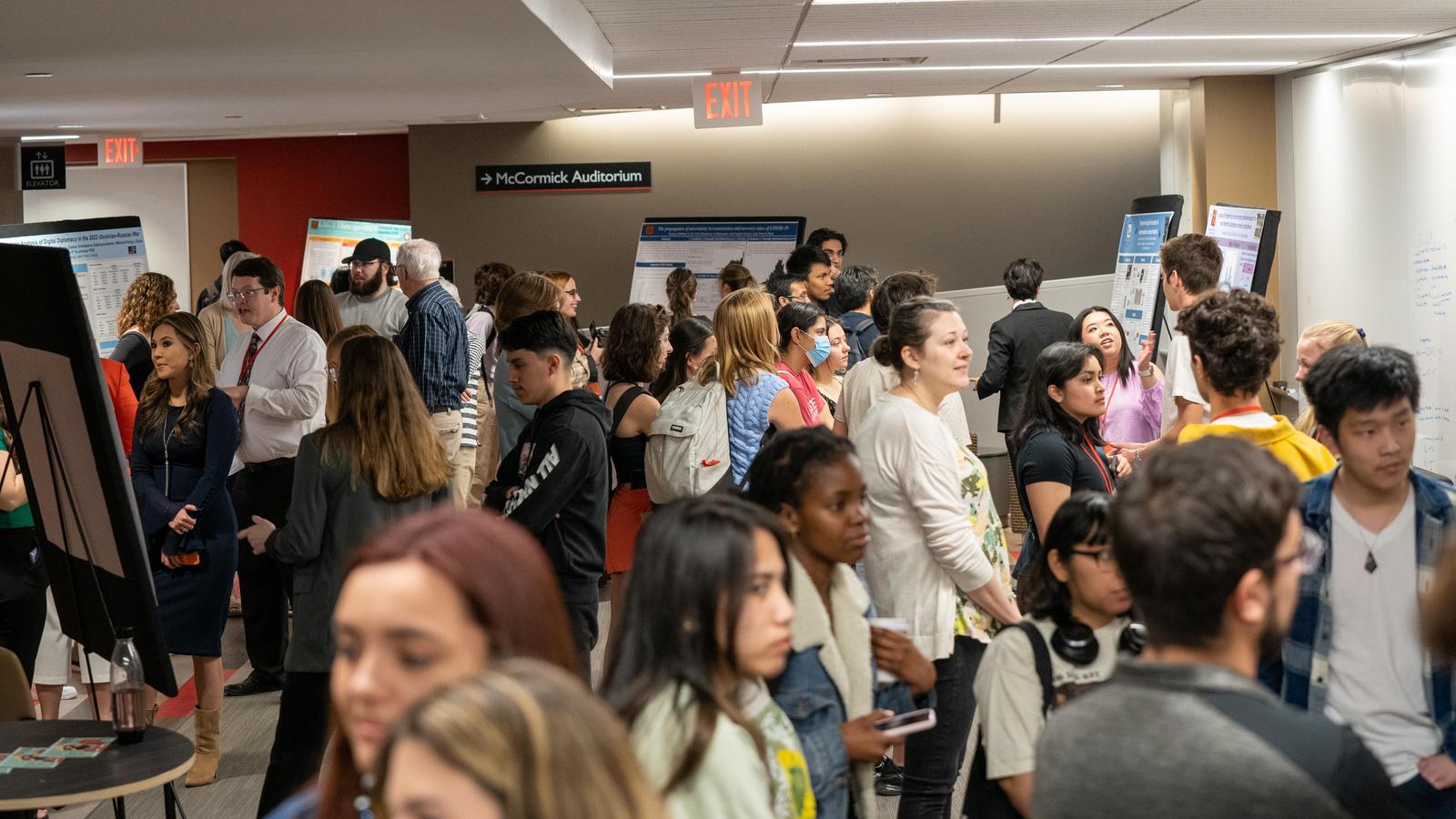 people presenting at listening at a poster session
