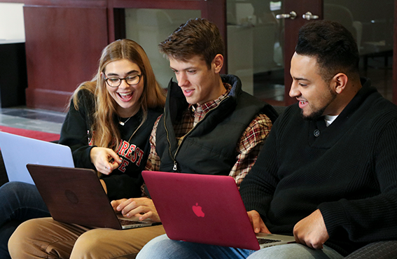a group of students excitedly working together