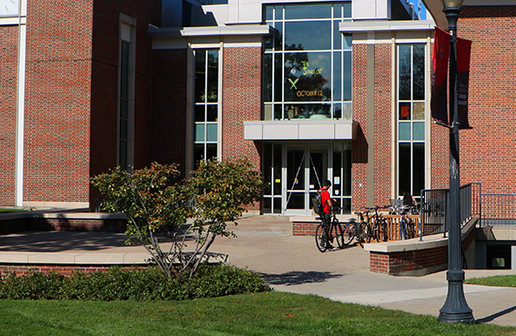 an exterior view of the library with students in the foreground