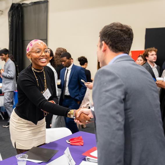 two people shaking hands at a networking events
