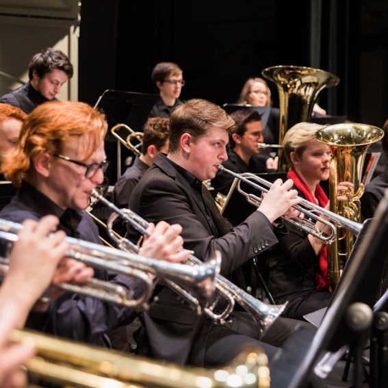 students playing instruments in a concert