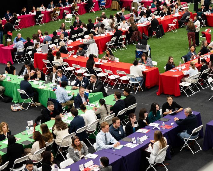 tables of students and professionals at the event