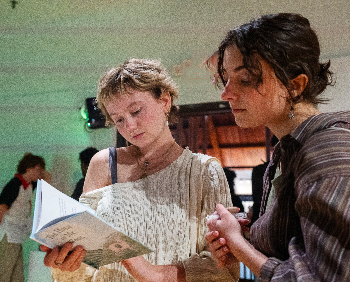 students looking at a book