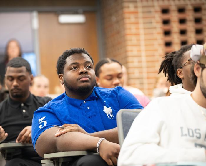 a student listening to someone speak