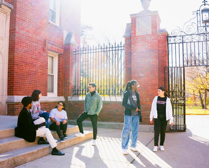 students sitting and talking by the gates