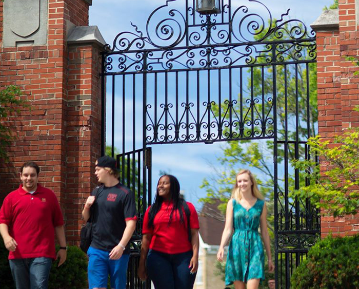students in front of Middle Campus gates