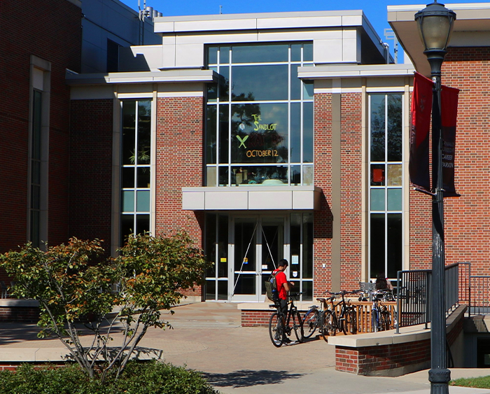 student parking bike in front of Donnelley and Lee Library 