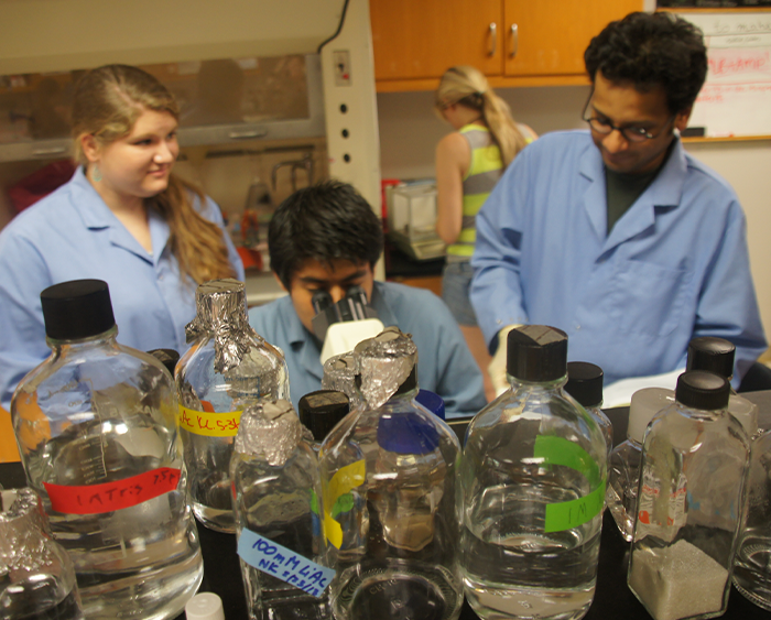 students and a professor in a lab