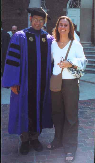 professor in graduation robes with student