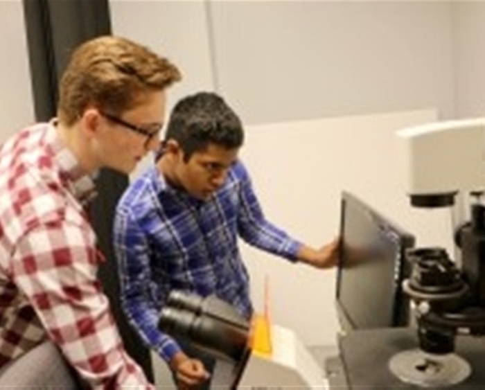 Two students looking at computer