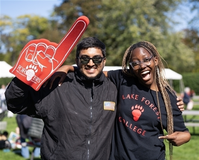 Two students with red foam hand