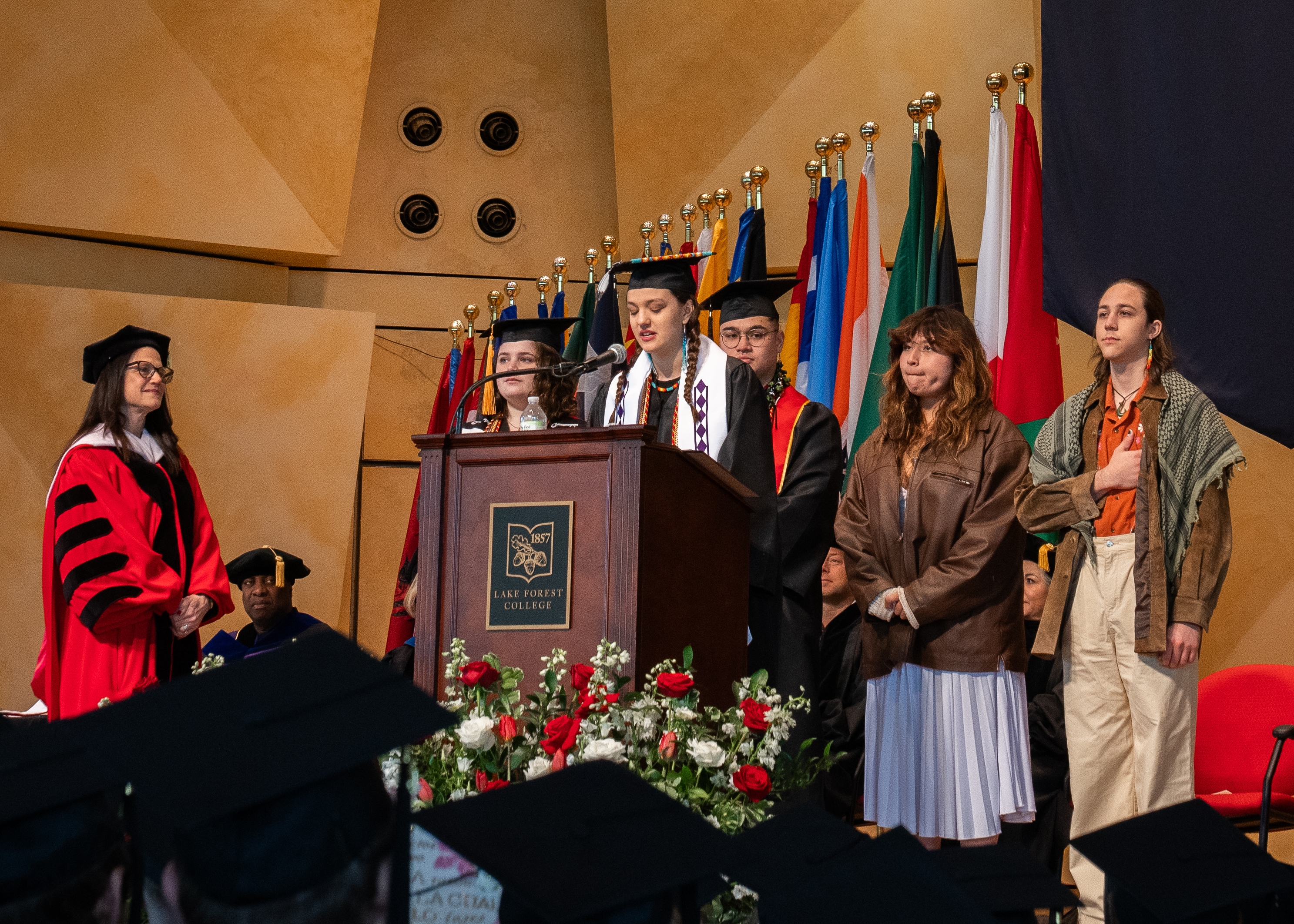 Native American students at graduation podium