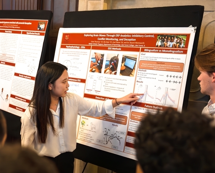 student presenting research poster