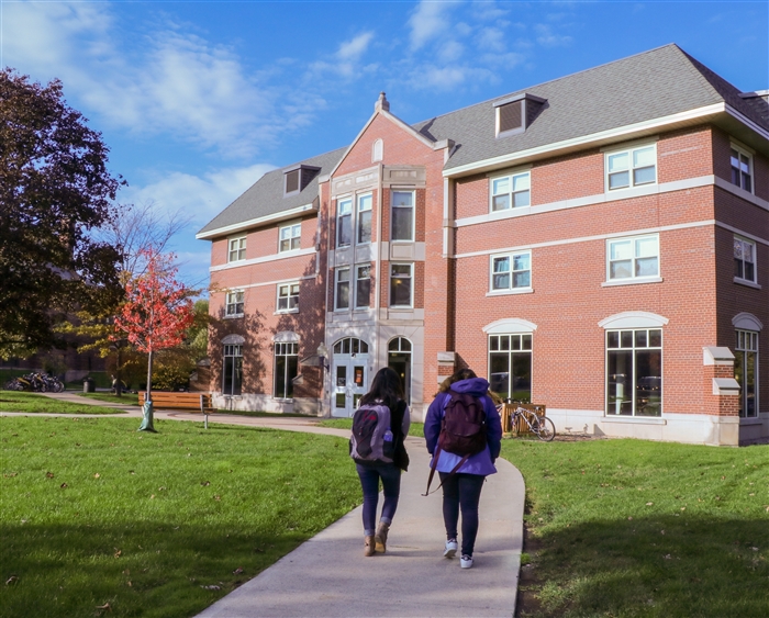 two students walking outside dorm
