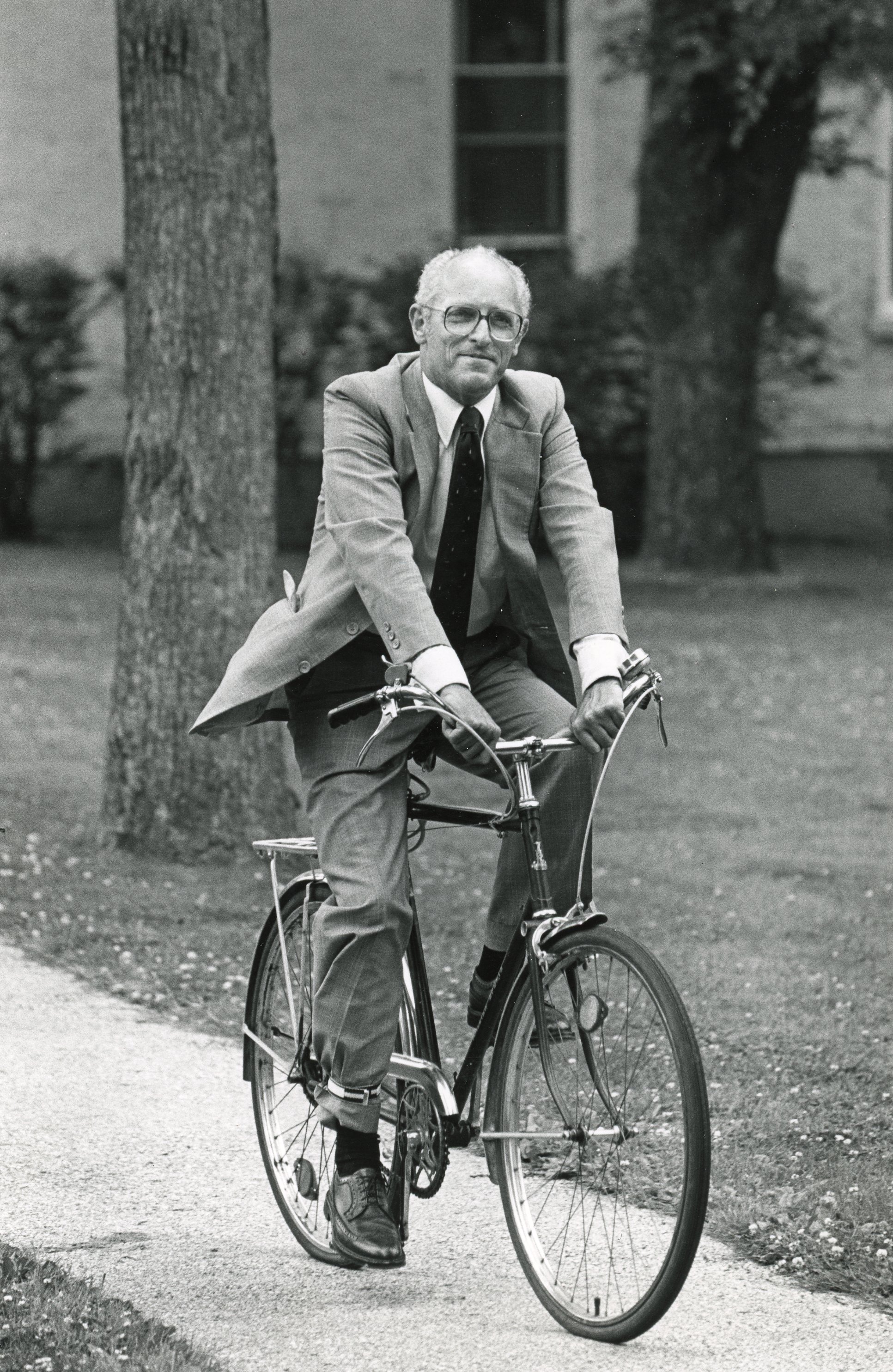 Man riding bike in suit