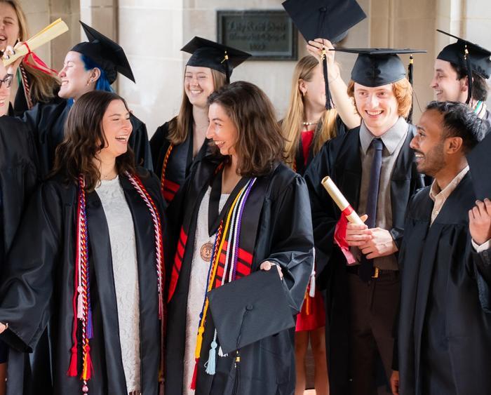 students in caps and gowns smiling