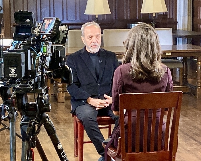 Ahmad Sadri seated during television interview