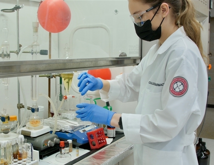 Student performing lab experiment