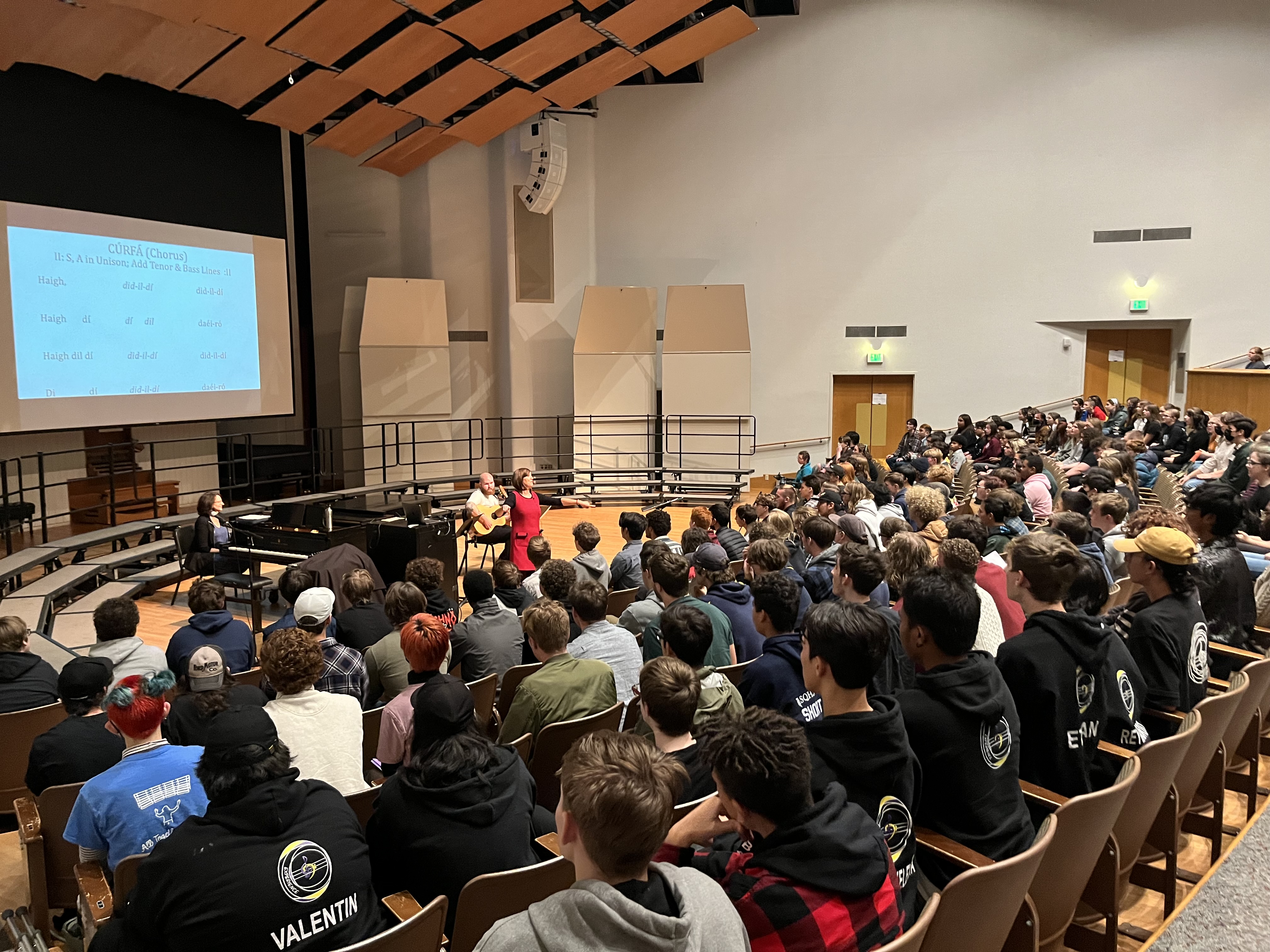 students rehearsing in a large group with anne barry