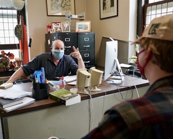 Professor Ben Goluboff meeting in office with student