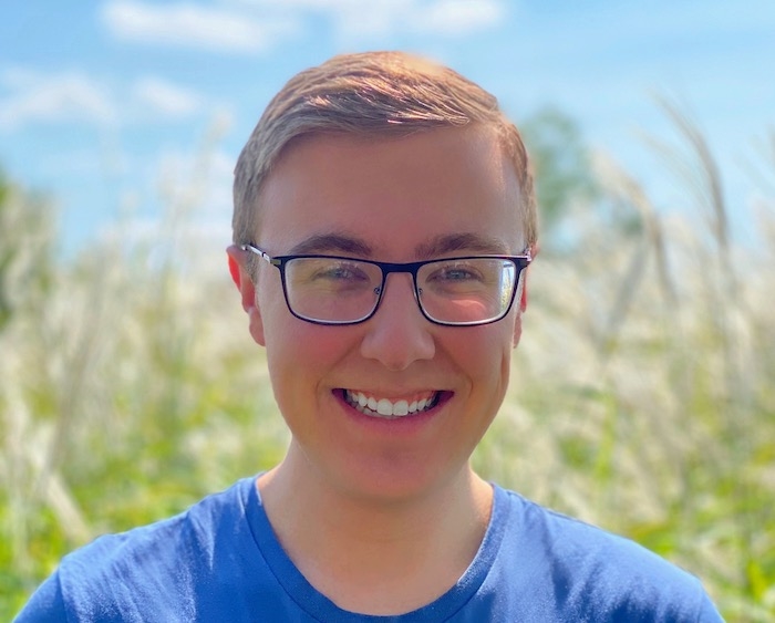 Photo of Adam Hartzer in a field