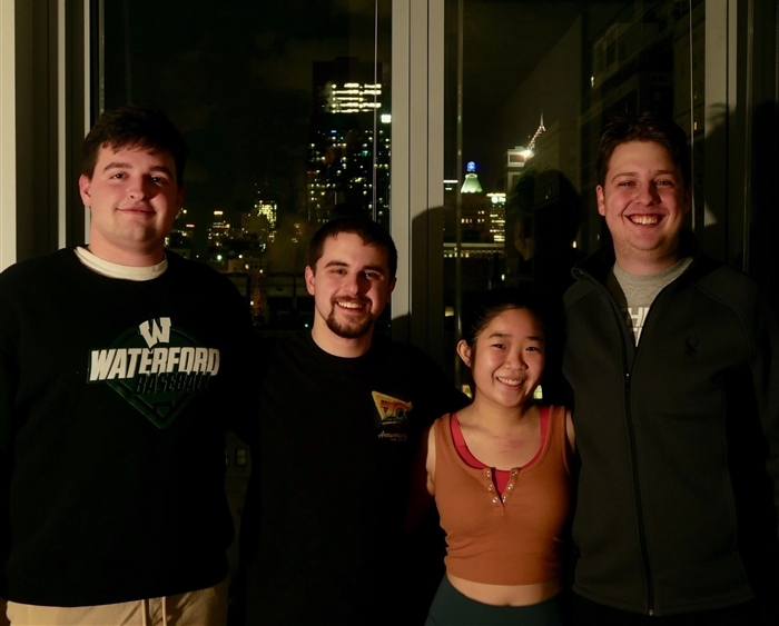 Four students inside with Chicago night skyline in background