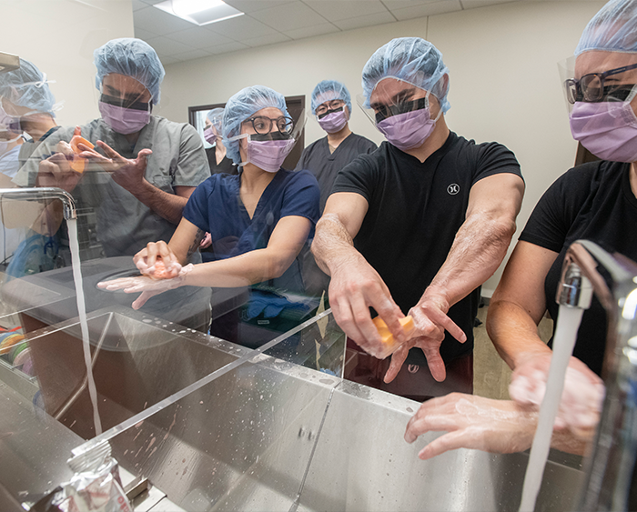 masked medical team washing hands