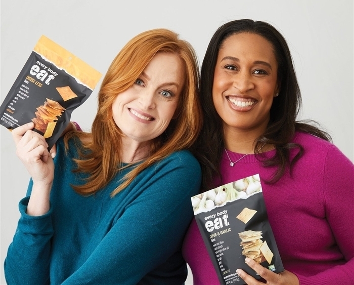 Trish Thomas and Nicole Wilson holding Every Body Eats snacks