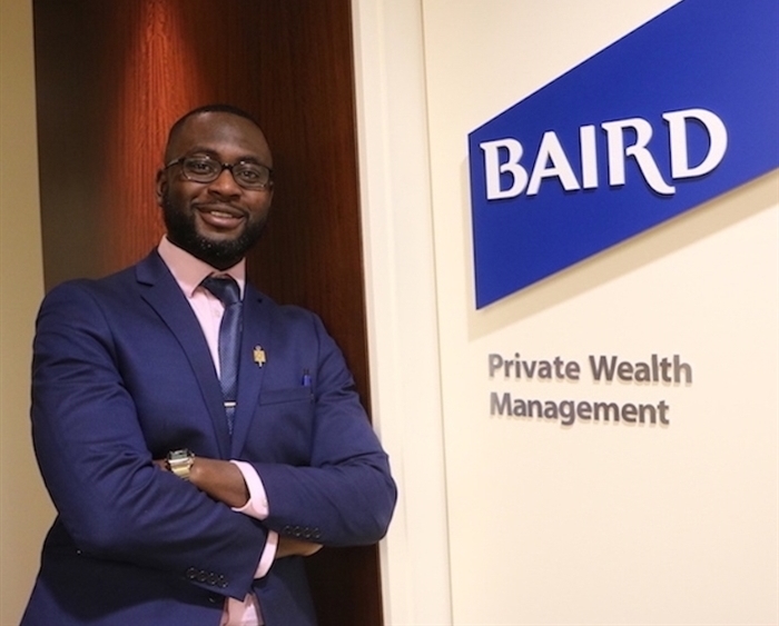 Intern crossing arms in front of Baird sign