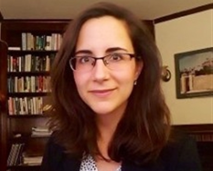 Professor in front of bookshelves