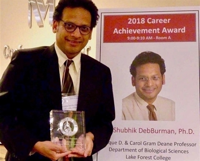 shubhik debburman posing with his award