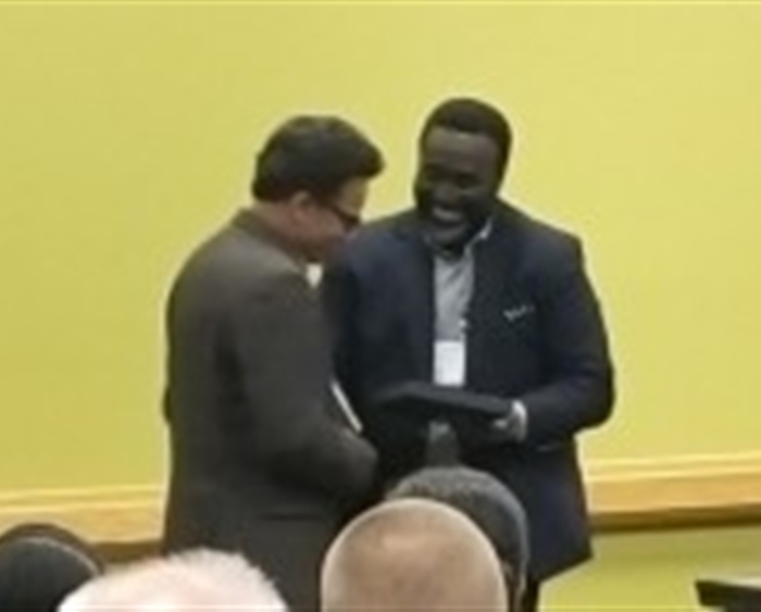 Professor Shubhik DebBurman receiving award