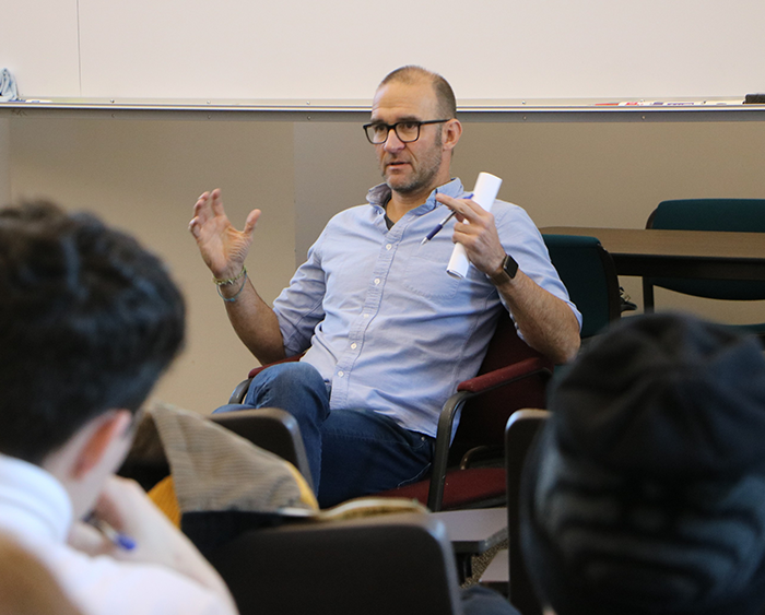 alumnus talking to students in lecture hall